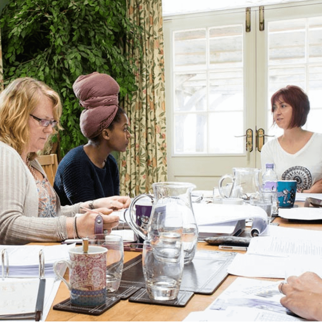 Team meeting at Raw Horizons discussing project strategies and collaboration.